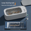Ultrasonic cleaner with a toothbrush and glasses inside on a blue background