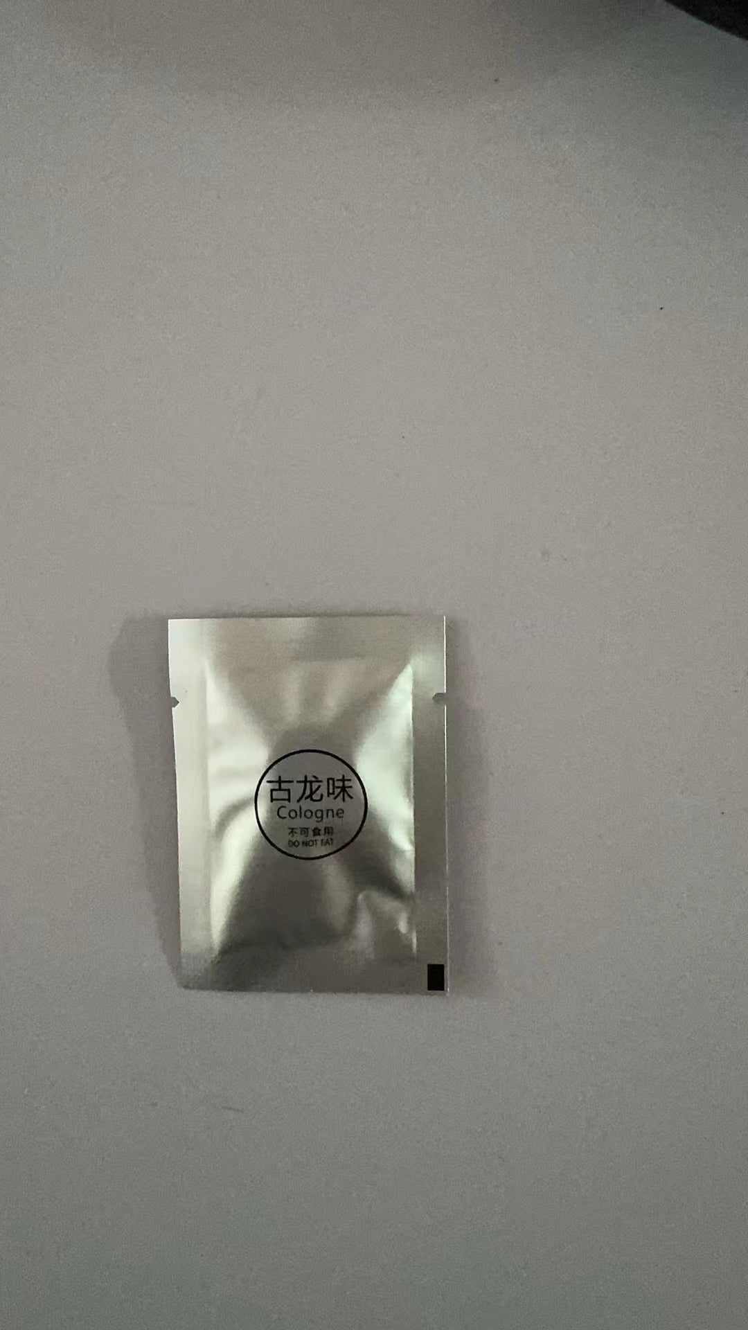 Small silver packaging on a light gray background