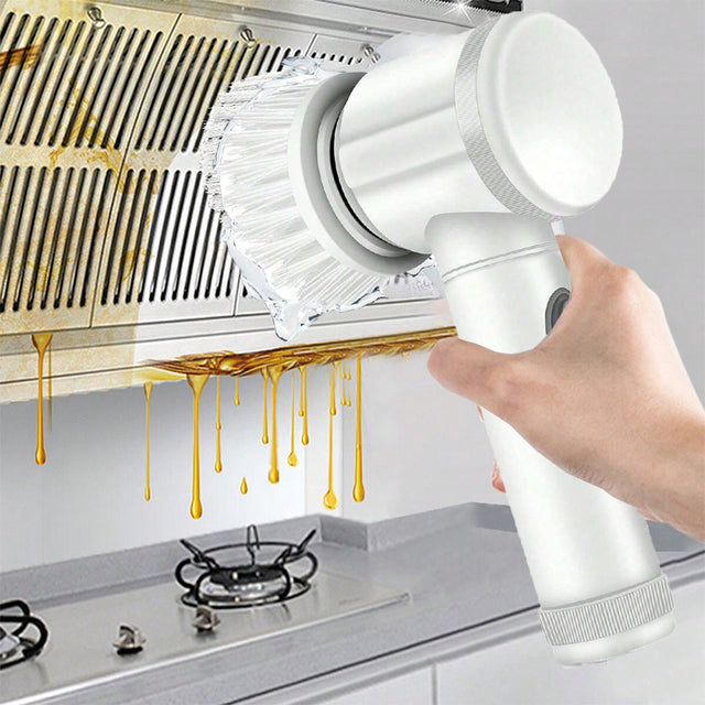 Hand using a white handheld cleaning brush to clean a kitchen exhaust hood.