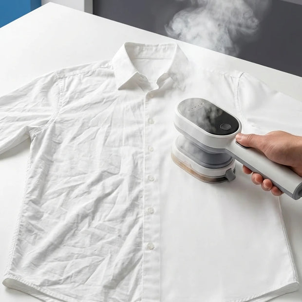 Person using a steamer on a white shirt with 'The Mod Nest' branding.