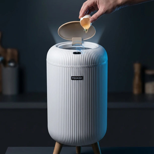 Smart trash can with a hand disposing of an egg shell, branded 'The Mod Nest'.