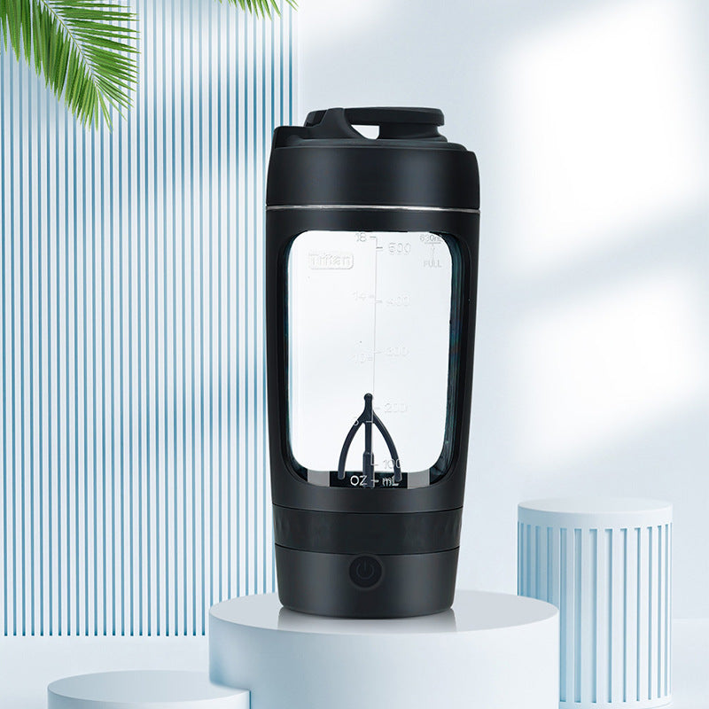 Black portable coffee maker on a white pedestal with a light blue background