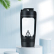 Black portable coffee maker on a white pedestal with a light blue background