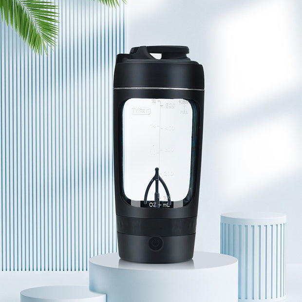 Black portable coffee maker on a white pedestal with a light blue background