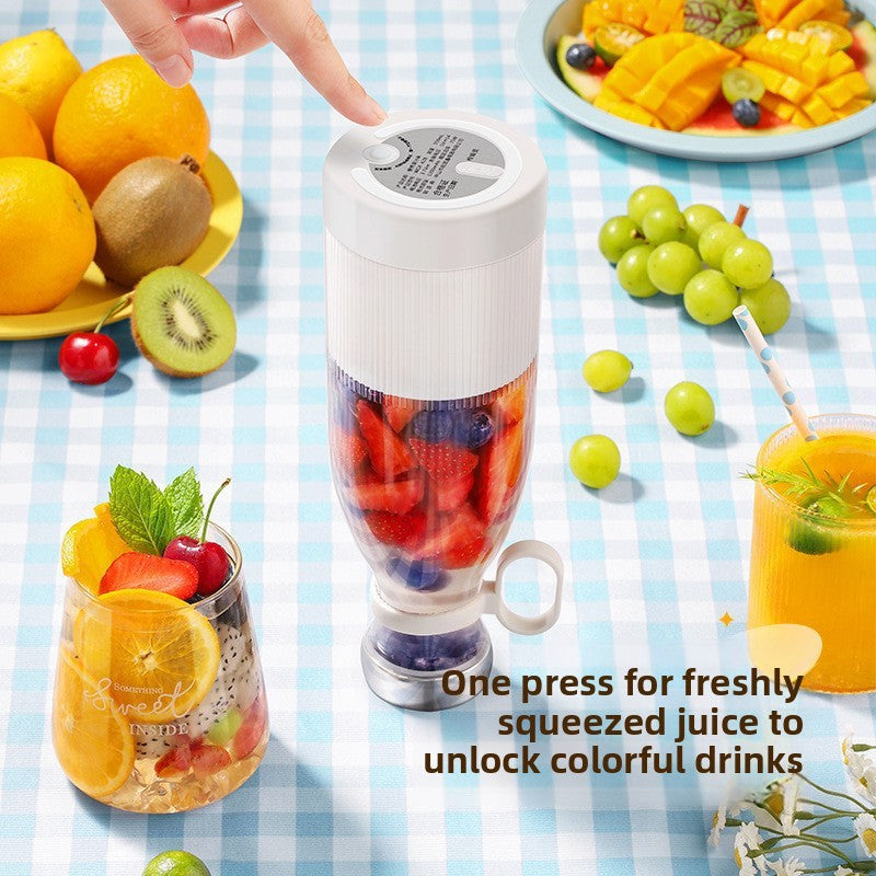 Portable blender with fruits and a glass of juice on a checkered tablecloth