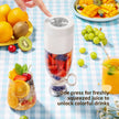 Portable blender with fruits and a glass of juice on a checkered tablecloth