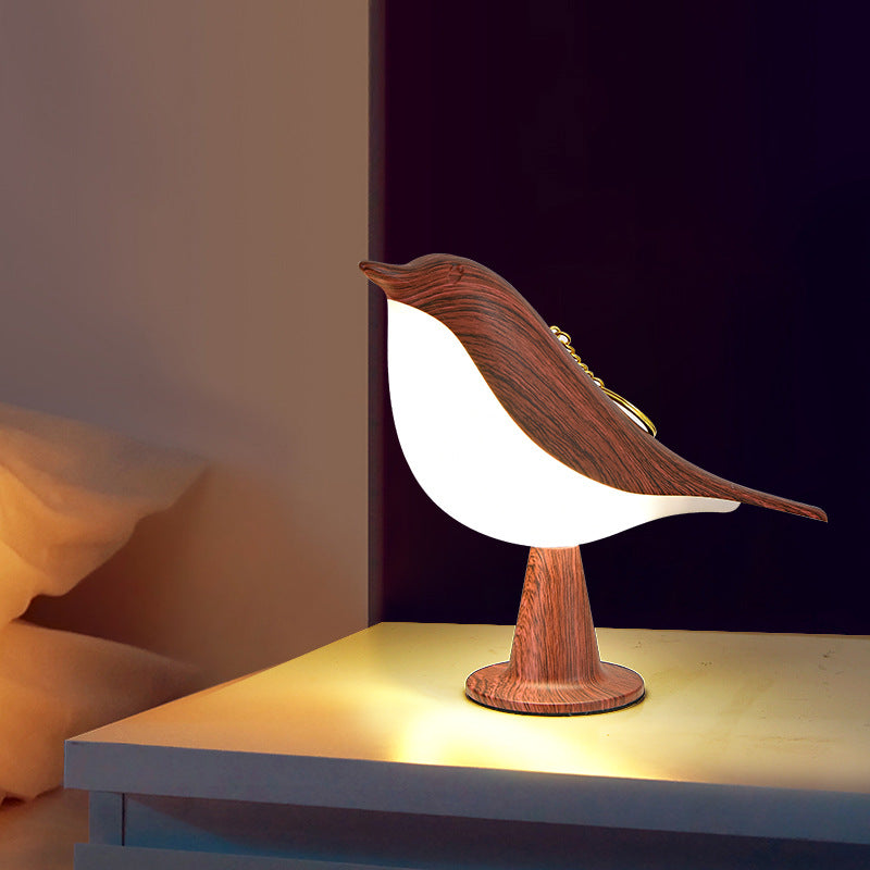 Wooden bird-shaped lamp on a surface with a blurred background