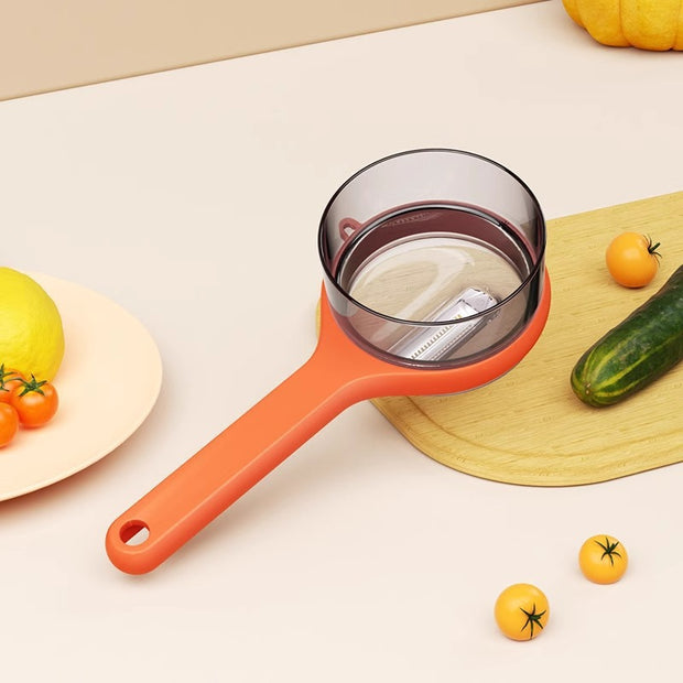 Orange kitchen strainer on a light surface with vegetables around
