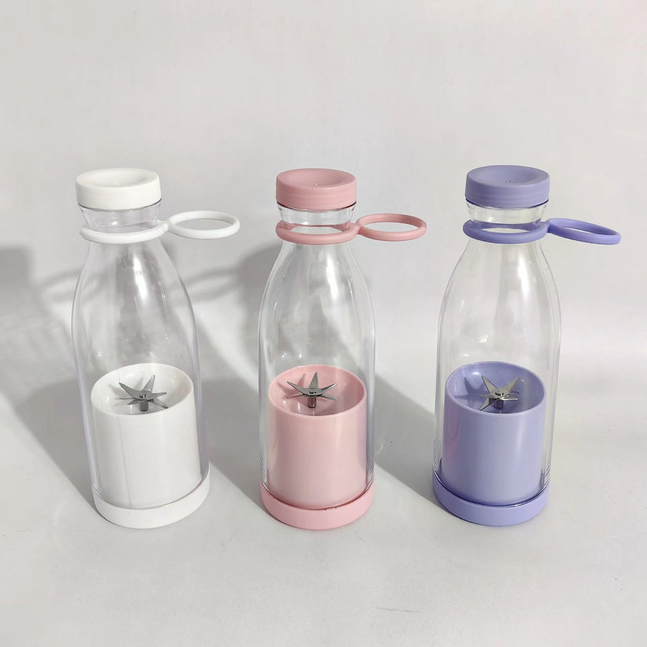 Three clear bottles with colorful lids and interior components on a light background
