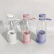 Three clear bottles with colorful lids and interior components on a light background