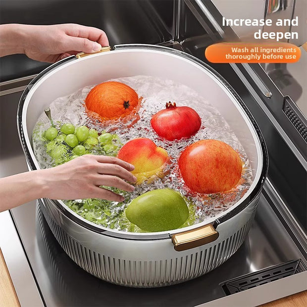 Fruits being washed in a large bowl with water on a kitchen counter.