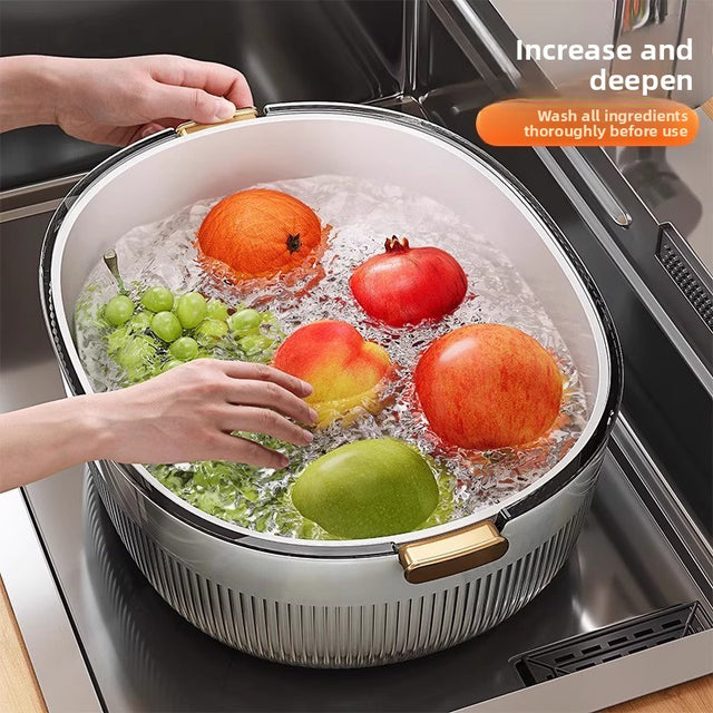 Fruits being washed in a large bowl with water on a kitchen counter.