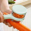 Person using a carrot peeler to remove the skin of a carrot.