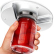 Hand holding a red gelatin dessert with a silver lid against a white background
