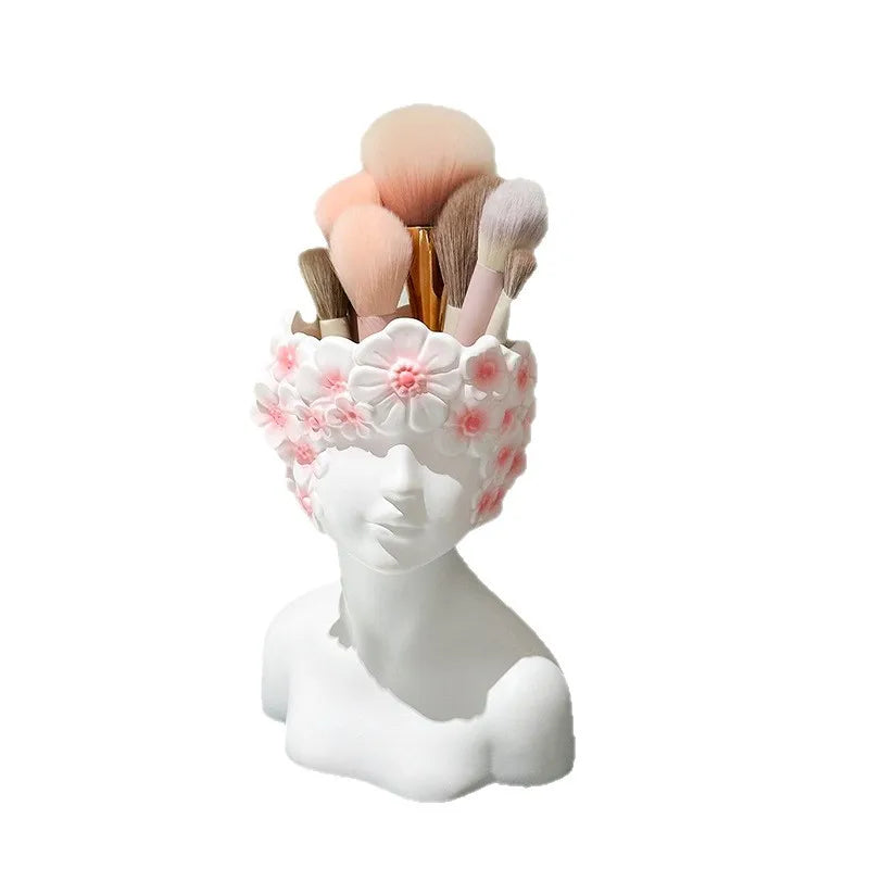 Makeup brush holder with floral design on a white background