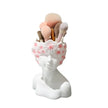 Makeup brush holder with floral design on a white background