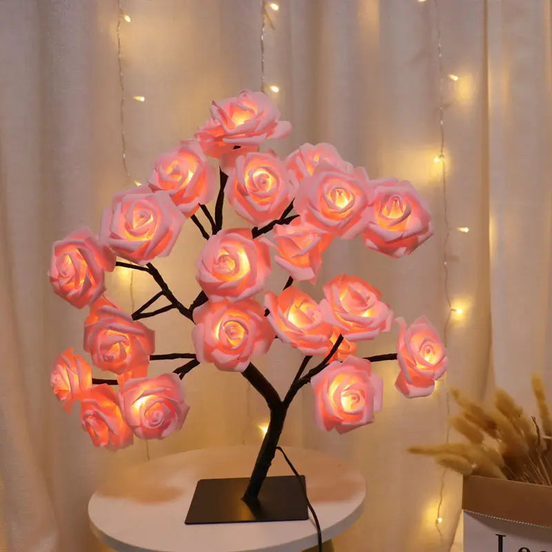Decorative lamp with pink roses on a white table against a light curtain background
