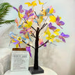 Decorative lamp with colorful butterfly-shaped lights on a white surface.