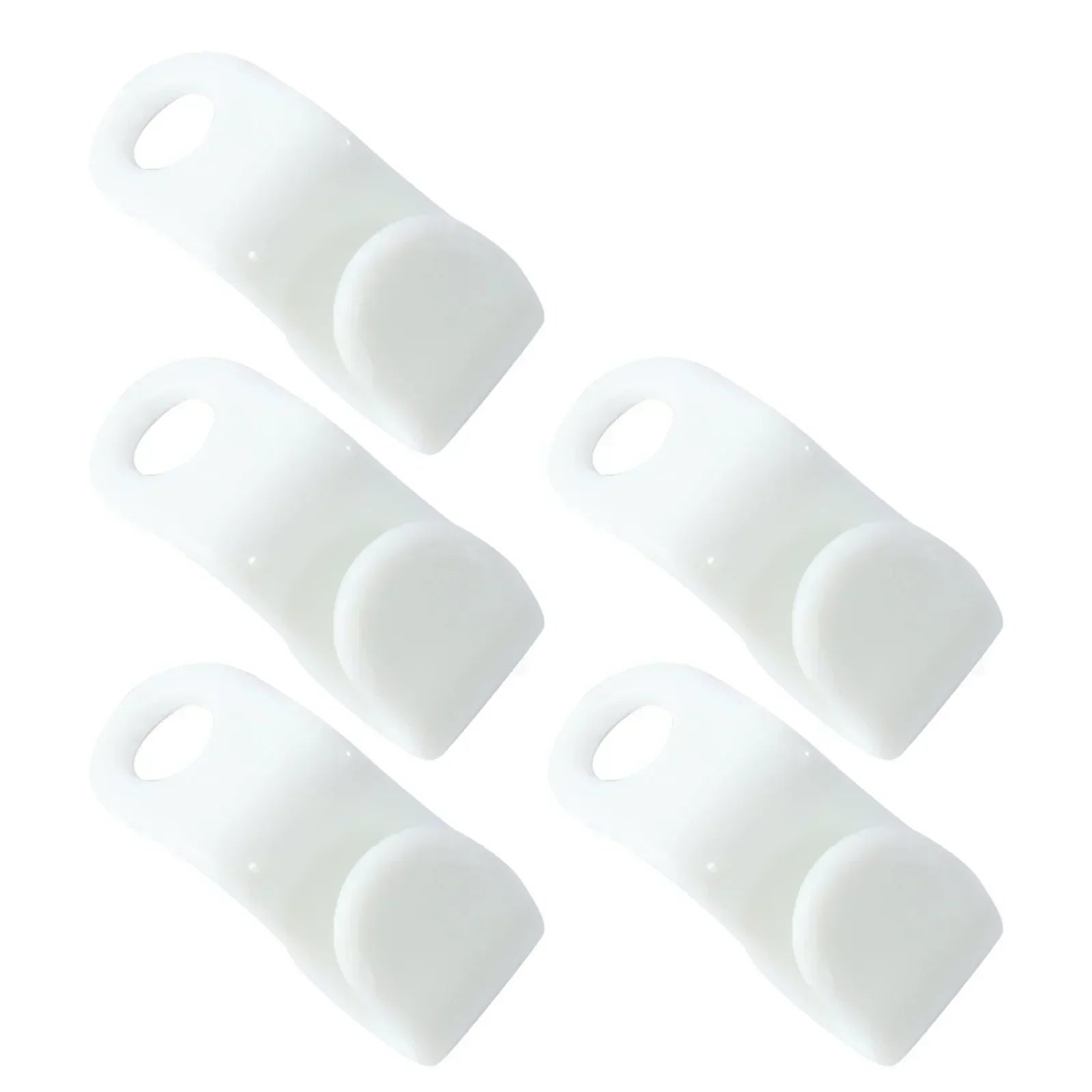Set of five white silicone coasters on a white background