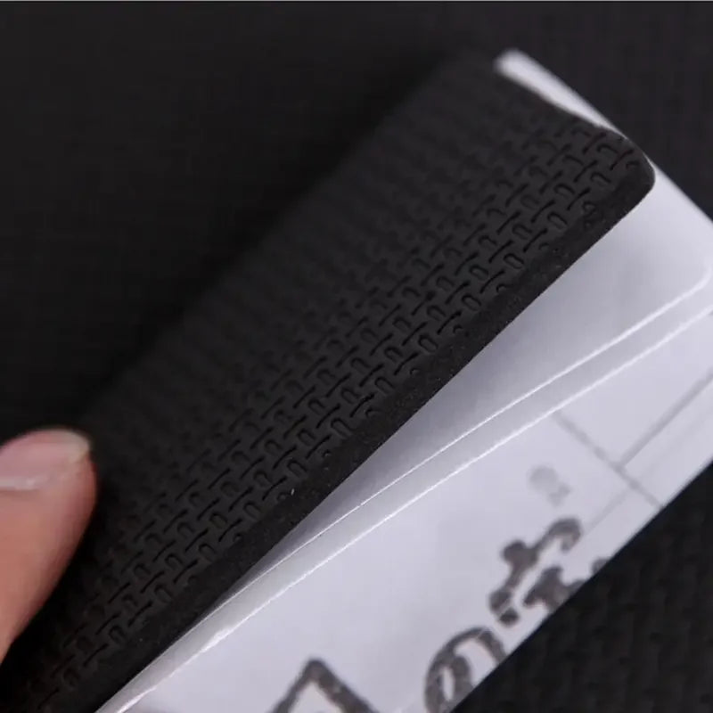 Close-up of a textured black strip on a white electronic device with a blurred background