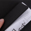 Close-up of a textured black strip on a white electronic device with a blurred background