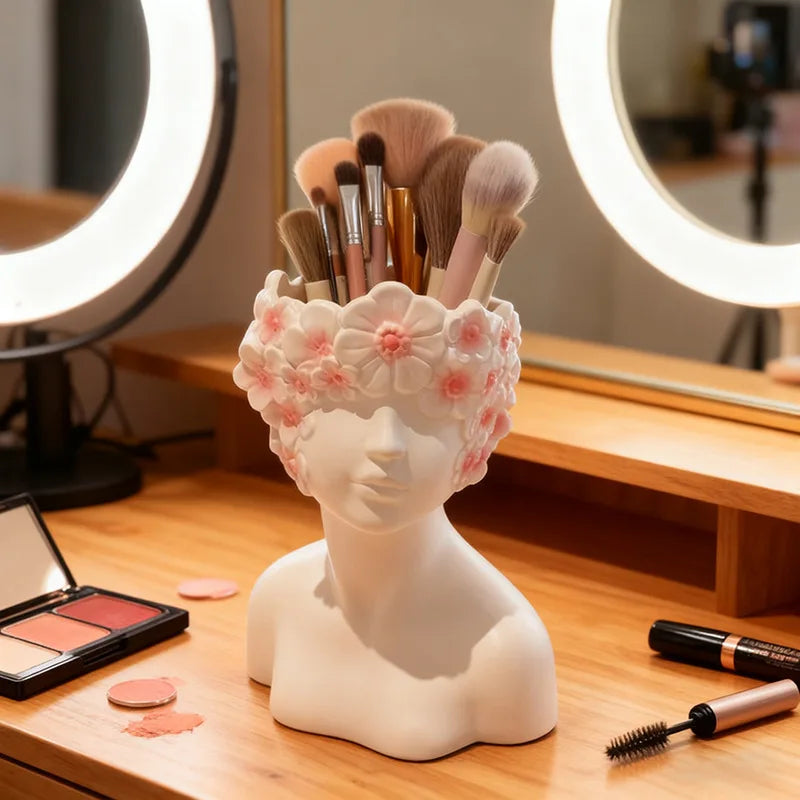 Makeup brush holder with brushes on a vanity table with makeup products.