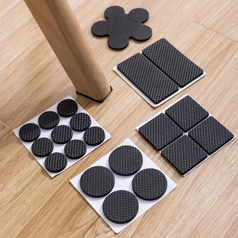 Black furniture pads on a wooden floor