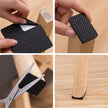 Black textured square being used as a furniture leg stopper on a wooden surface.