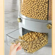 Automatic pet feeder dispensing kibble with a hand reaching to grab some.