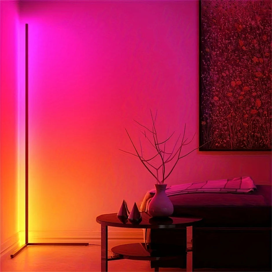 Modern interior with a gradient wall light, table with decorative items, and abstract painting.