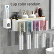 Bathroom shelf with toothbrushes, cups, and toiletries on a tiled wall.
