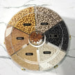 Round display of various grains with labels on a marble surface