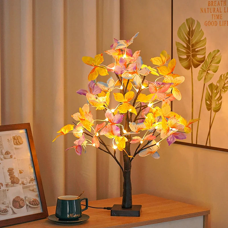 Decorative LED tree lamp on a table with a warm ambiance