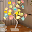 Colorful LED flower lamp on a wooden table with a blurred background