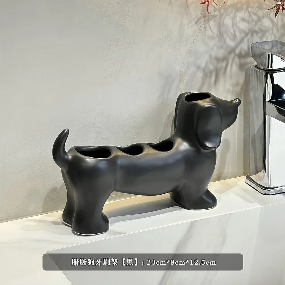 Black dog-shaped toothbrush holder on a white surface with a neutral background