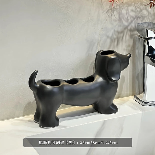 Black dog-shaped toothbrush holder on a white surface with a neutral background
