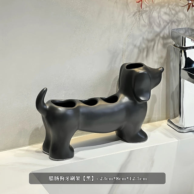 Black dog-shaped toothbrush holder on a white surface with a neutral background