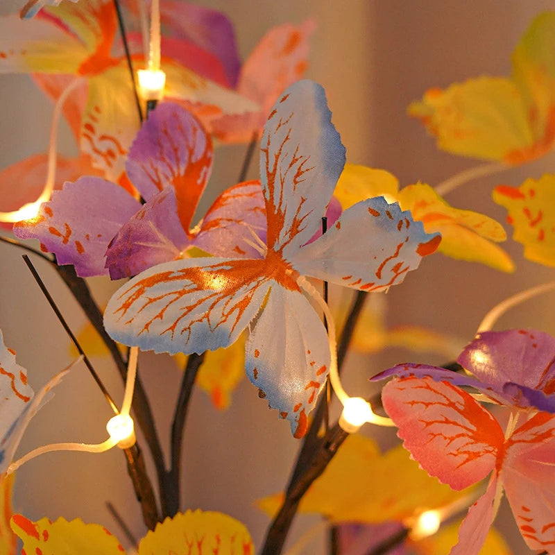 Decorative floral arrangement with butterfly-shaped lights on a blurred background