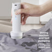 Hand using a white handheld device on a gray surface with text about suction and pumping speed.