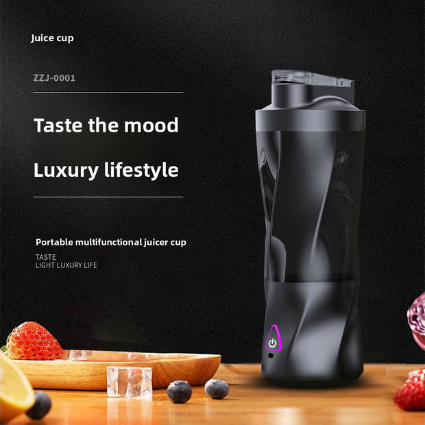 Black portable juicer cup on a wooden surface with fruits and ice cubes, against a dark background.