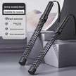 Pair of black exercise sticks with spring mechanism on a gray background