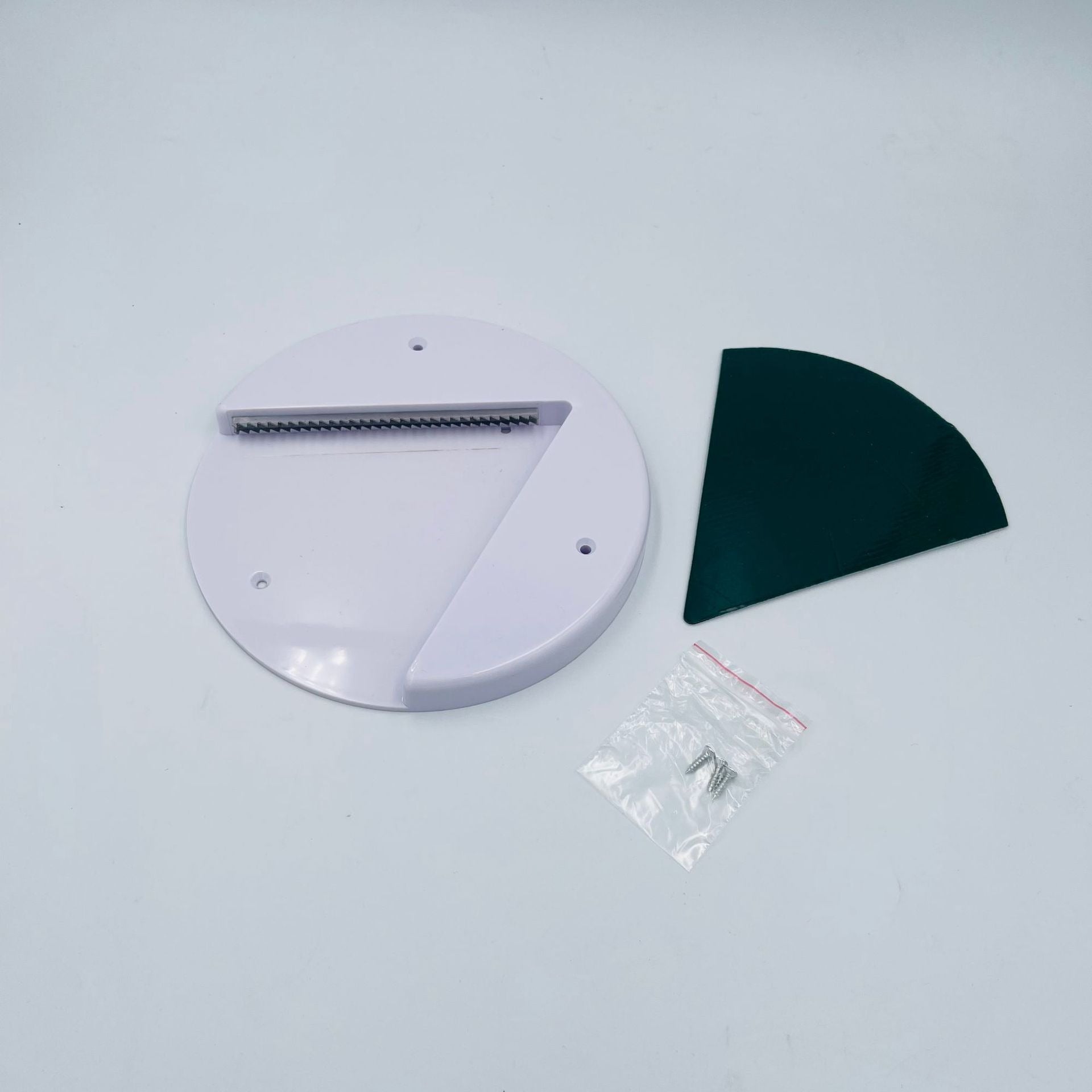 White circular object with a black curved piece on a light gray background