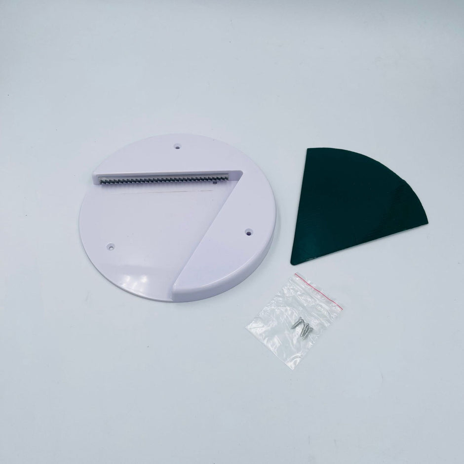 White circular object with a black curved piece on a light gray background
