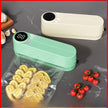 Green vacuum sealer on a gray surface with food items around