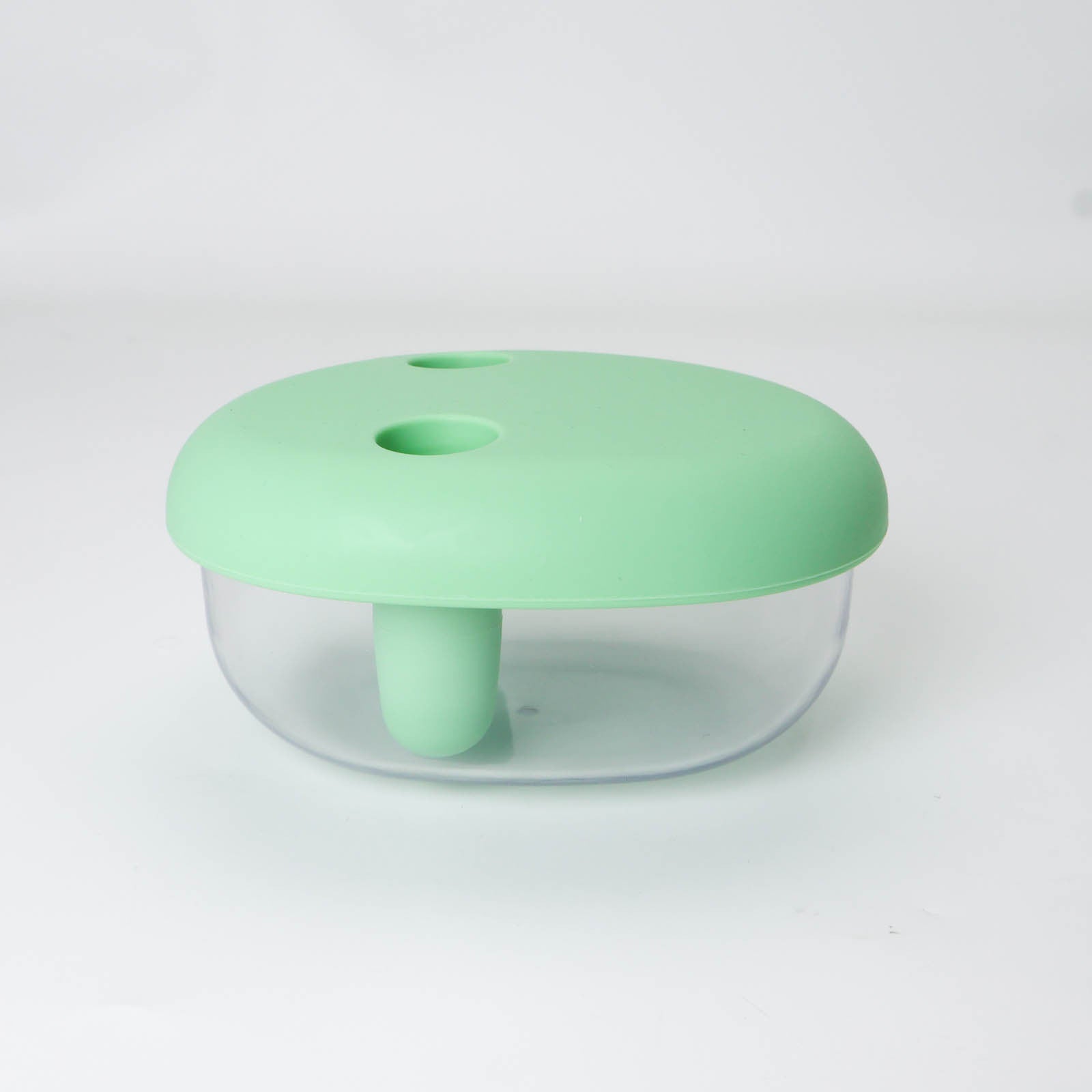 Clear container with a green lid on a white background