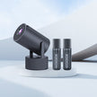 Black microphone setup on a white platform with a gradient blue background