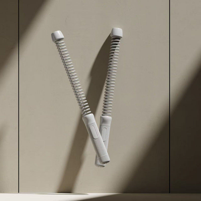 Two white hair straightening tools on a beige background