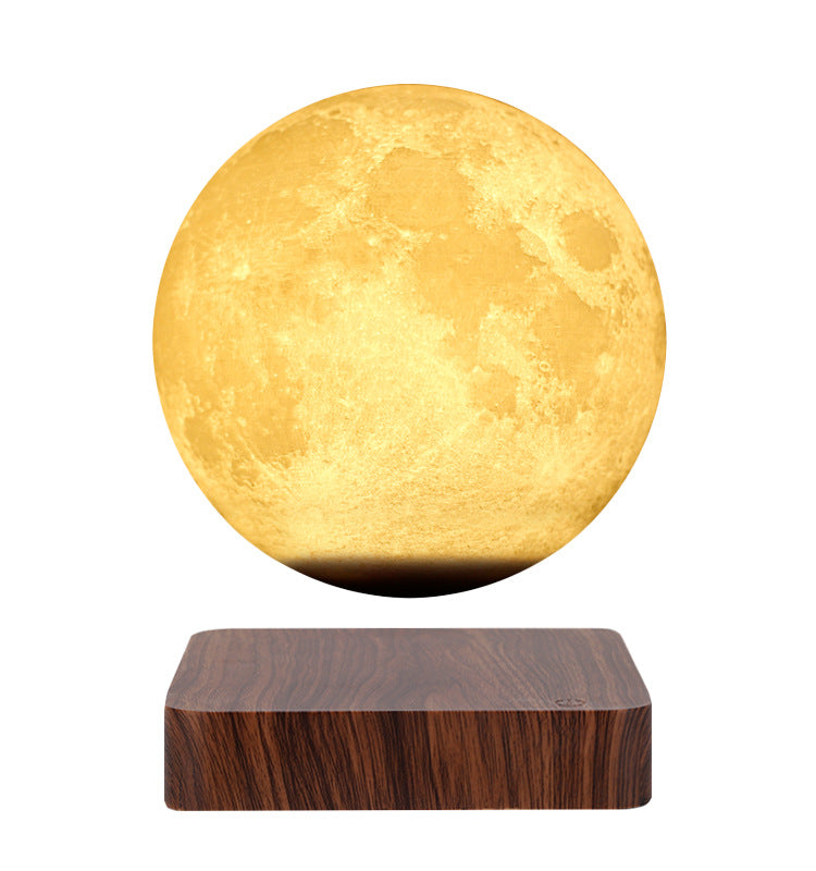 Levitating moon lamp on a wooden base with a white background