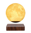 Levitating moon lamp on a wooden base with a white background