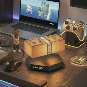 Levitatic wireless charging pad on modern desk with gaming setup, laptop, controller, and ambient lighting